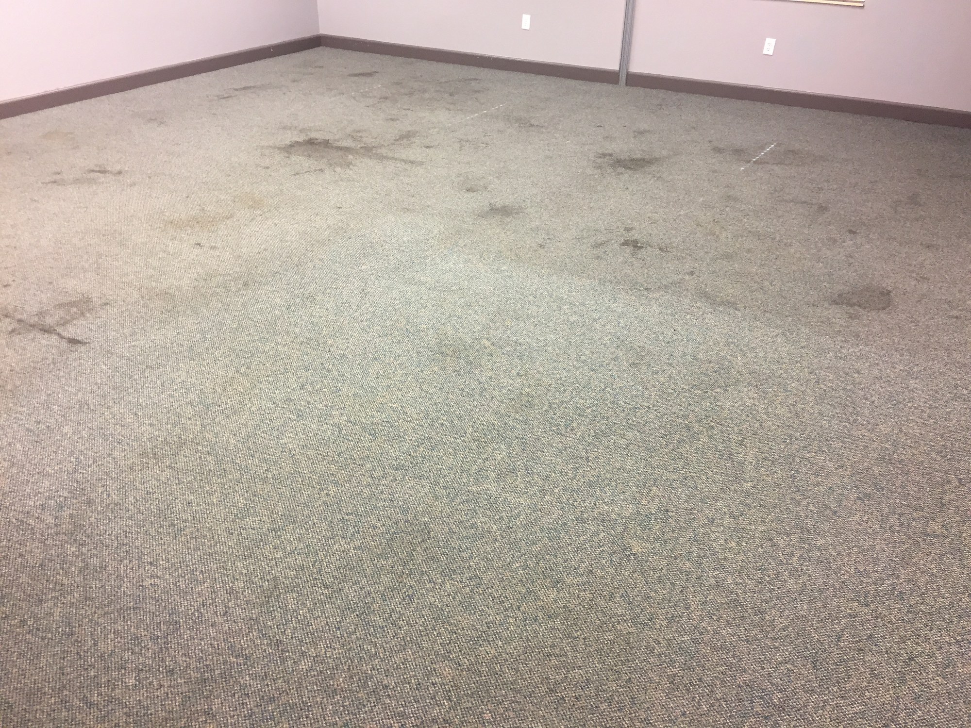 Stained commercial carpet before Mission Floor Care cleaning